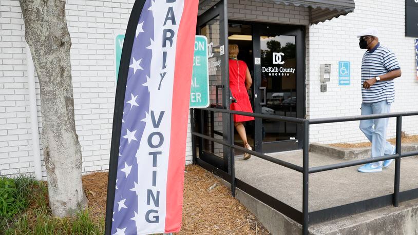 People walk through the entrance at the Voter Registration & Elections in Dekalb during the first day of early voting on Monday, June 13, 2022. Votes are being collected through Friday in several runoff races throughout metro Atlanta. Miguel Martinez / miguel.martinezjimenez@ajc.com
