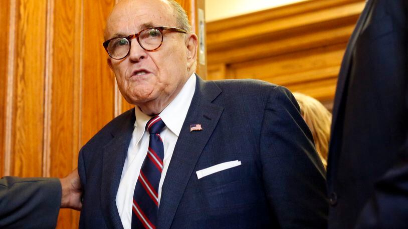 Rudy Giuliani walks to a senate hearing at the Georgia State Capitol in Atlanta on Thursday, December 3, 2020. The Georgia Senate Committee on Judiciary has formed a special subcommittee to take testimony of elections improprieties and evaluate the election process. (Rebecca Wright for the Atlanta Journal-Constitution)