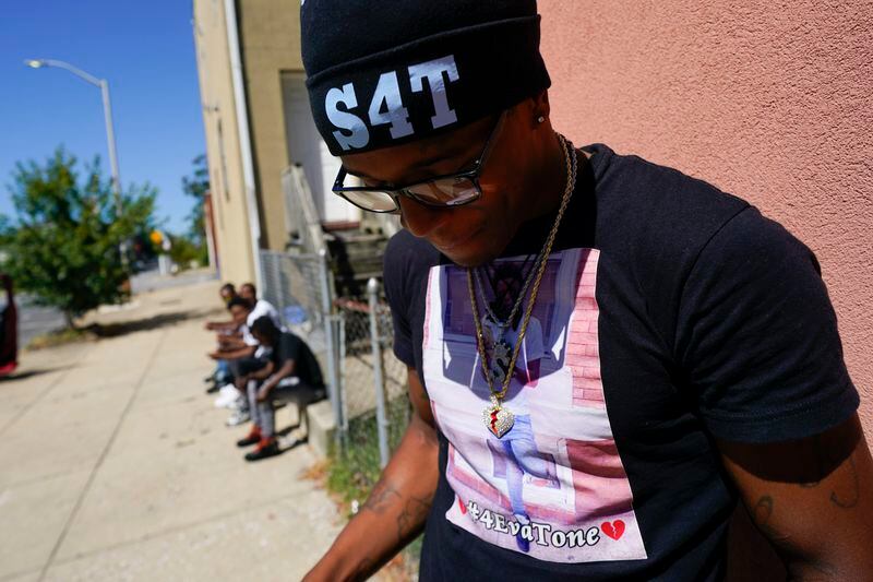 A friend of Antonio Lee wears a shirt and a hat honoring Antonio Lee following a funeral service for Lee, Thursday, Aug. 31, 2023, in Baltimore. Lee, 19, a squeegee worker was killed during a shooting as he panhandled in a Baltimore street corner. (AP Photo/Julio Cortez)