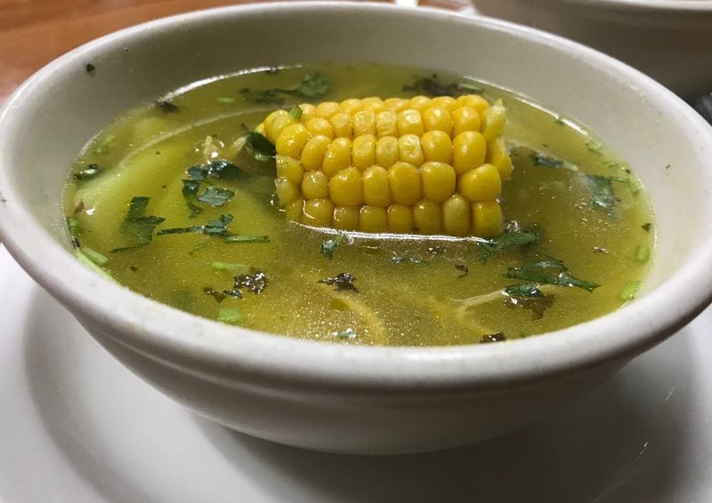 The lunch special at La Casona always comes with a cup of homemade soup. Pictured is chicken, corn and potato soup. LIGAYA FIGUERAS / LFIGUERAS@AJC.COM