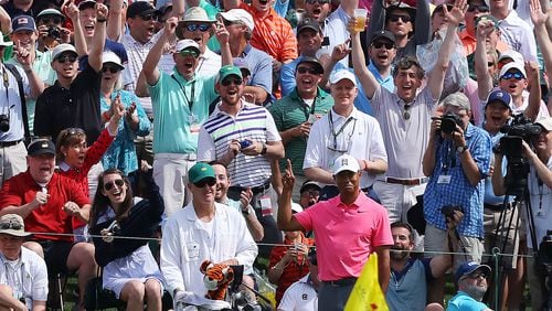 The massive gallery following Tiger Woods reacts as he chips in for an eagle on the second hole during his practice round for the Masters at Augusta National Golf Club on Monday.