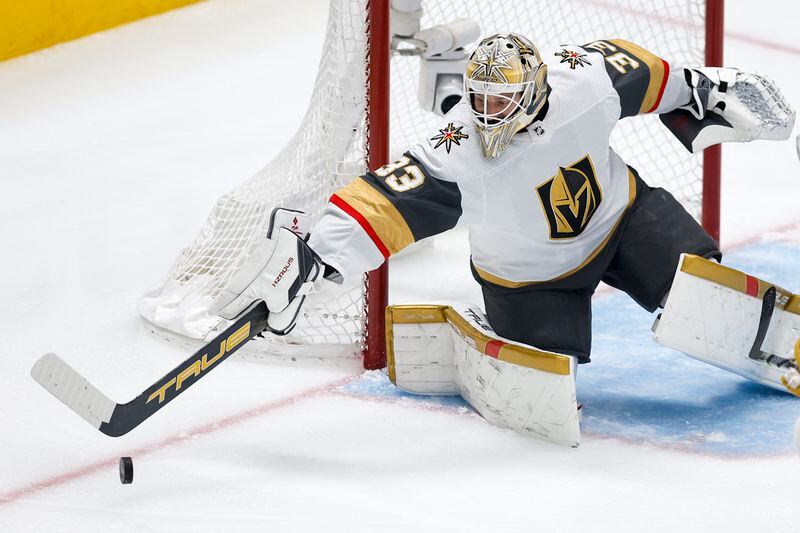Vegas Golden Knights goaltender Adin Hill deflects a shot during the first period in Game 7 of an NHL hockey Stanley Cup first-round playoff series against the Dallas Stars, Sunday, May 5, 2024, in Dallas. (AP Photo/Brandon Wade)