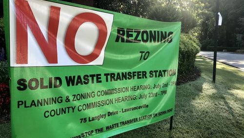A sign protesting the proposed Ozora Road Solid Waste Transfer Station, posted outside the Kensington Forest subdivision near Loganville. TYLER ESTEP / TYLER.ESTEP@AJC.COM
