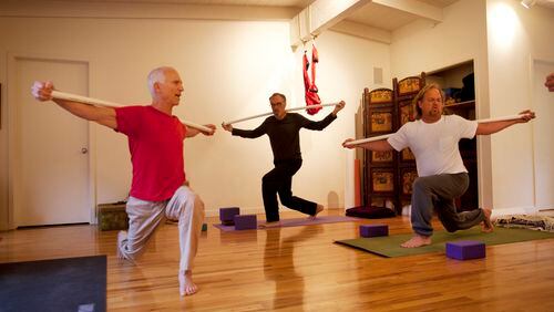 Paul Gould, left, teaches a yoga class at Namastay Yoga in Felton, Calif. Gould has a weekly class where he teaches a group of several men -- regulars who've become friends, including Jim Scheer, center, and Jon Troutner, right. (Patrick Tehan/Bay Area News Group/TNS)