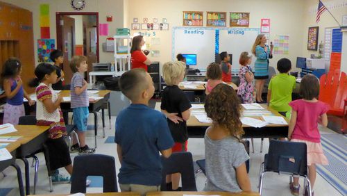 Lakeway Elementary School Principal Sam Hicks (far right) leads the pledge of allegiance with second-grade teacher Nicolle Halprin and her class on the first day of school Aug. 24. Lake Travis school district officials reported that 9,048 students attended classes on opening day, and enrollment has now surpassed the 9,100-mark.