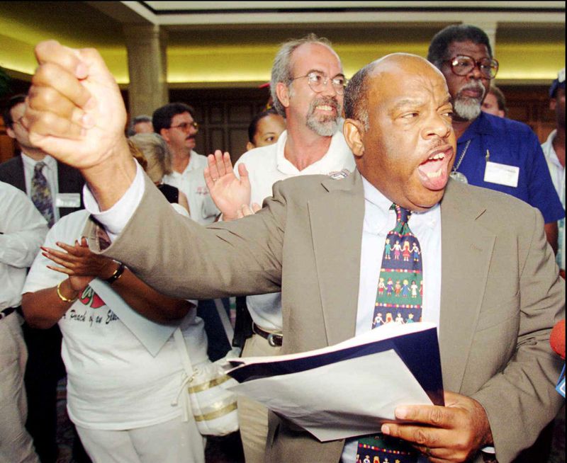 John Lewis continued his protest activism while serving in Congress. (He's seen here leading a 1995 demonstration at a Medicare conference in Marietta.) Although he is known as a stalwart liberal Democrat, Lewis was in sharp disagreement with President Bill Clinton in the 1990s over welfare reform, the death penalty, military intervention and the NAFTA trade agreement. (John Bazemore / AP)