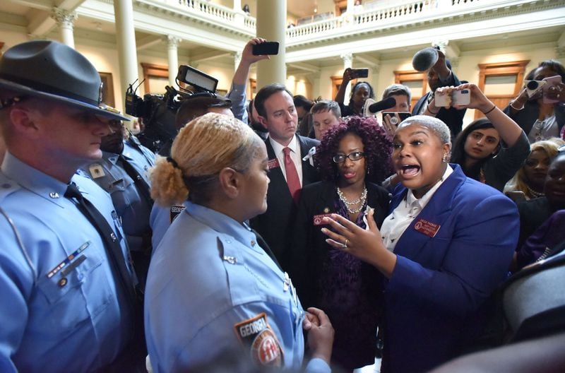 State Rep. Erica Thomas speaks with a Georgia State Patrol officer after the anti-abortion bill passed the House.  HYOSUB SHIN / HSHIN@AJC.COM