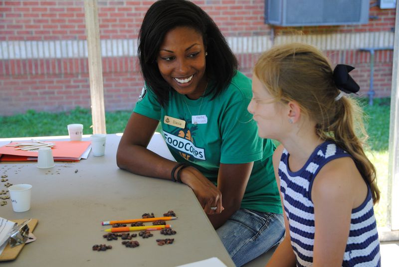 Former FoodCorps Georgia service member Dasia Harmon uses seeds to do a “skip counting” math lesson with a student. 
