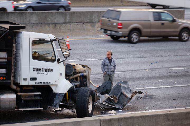 A person surveys a vehicle accident in Atlanta on Tuesday, April 12, 2022. (Arvin Temkar / arvin.temkar@ajc.com)