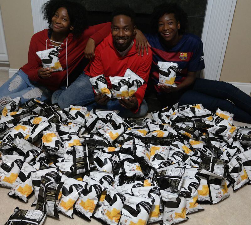 Dondre Anderson (center) and his two daughters, Amari (left) and Amina (right), launched Symphony Chips in 2015. The snacks are now available in four locations in Atlanta. CONTRIBUTED BY DONDRE ANDERSON