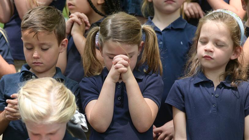 Kindergarten students from Fellowship Christian School bow their heads in prayer during the National Day of Prayer on Thursday, May 5, 2022. Natrice Miller / natrice.miller@ajc.com)