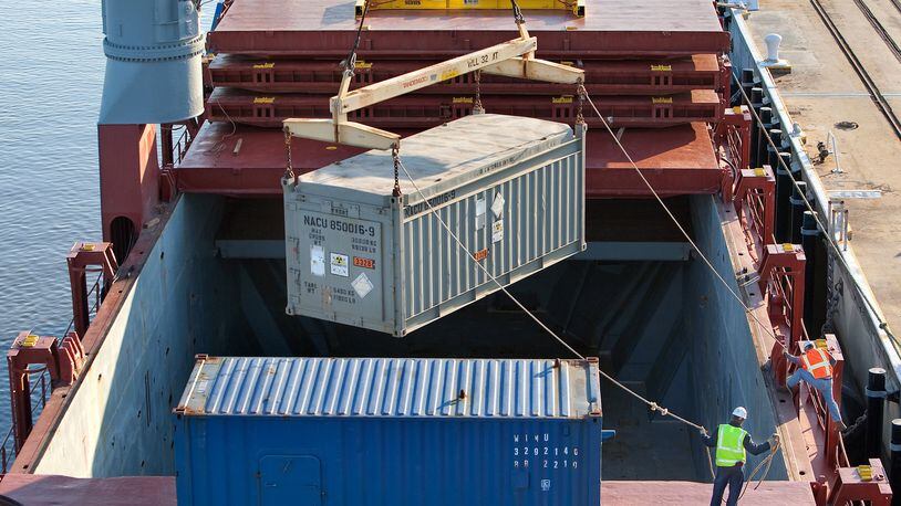 A massive crane gingerly lifts a container of highly-enriched uranium from the cargo hold of a ship arriving at the Charleston Weapons Station near Goose Creek, S.C., from Chile. The container was bound for the Savannah River Site. (AP Photo/Mic Smith)