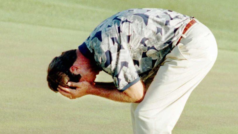 Ben Crenshaw holds his head as he weeps on the 18th green at Augusta National after sinking a putt to win The Masters.  (KEVIN KEISTER/AJC staff)