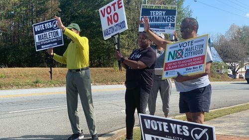 Supporters and opponents of the Mableton cityhood movement rally near a polling precinct Tuesday.