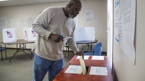 Dacula resident Denis Haynes Jr. casts his paper ballot during a special election in March for the City Council. Georgia’s delayed primary election will be held June 9.(ALYSSA POINTER/ALYSSA.POINTER@AJC.COM)