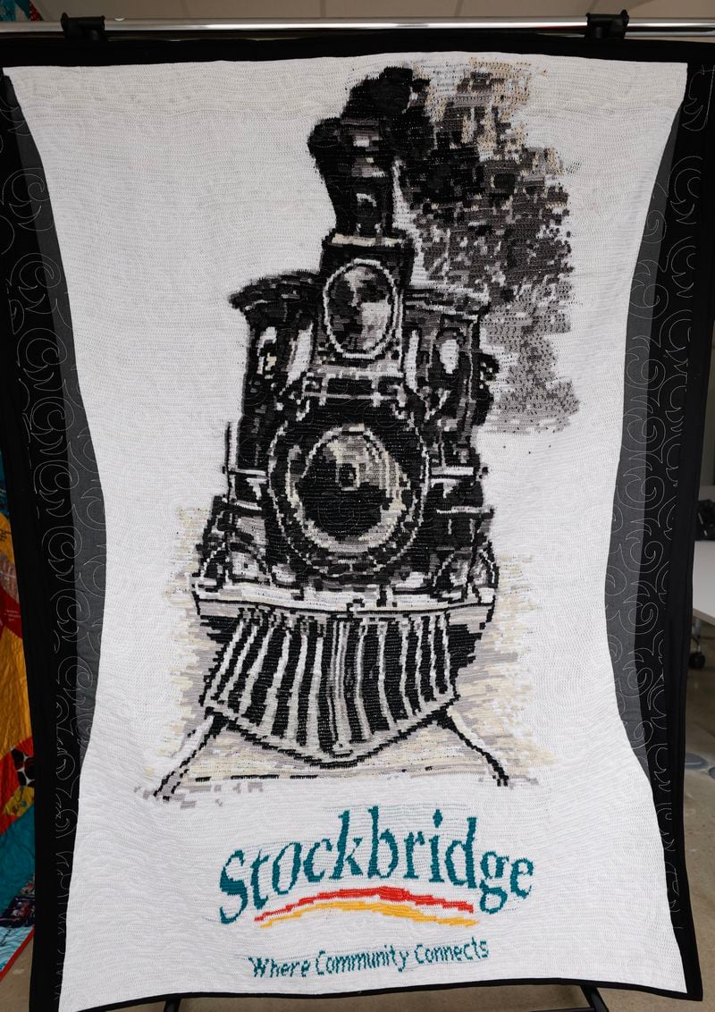 Views of a steam locomotive tapestry crocheted by Cheryl Baugh. The quilt was created to celebrate the 100th birthday of the city of Stockbridge. (Natrice Miller/ Natrice.miller@ajc.com)