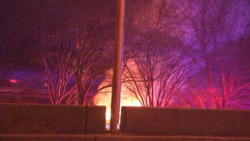 A Chrysler 200 being pursued by Georgia State Patrol troopers burst into flames Friday morning after it hit a light pole and a tree on the Buford Spring Connector, authorities said.