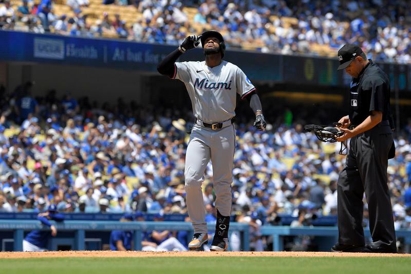 Miami Marlins' Bryan De La Cruz gestures as he scores after hitting a solo home run during the fourth inning of a baseball game against the Los Angeles Dodgers Wednesday, May 8, 2024, in Los Angeles. (AP Photo/Mark J. Terrill)