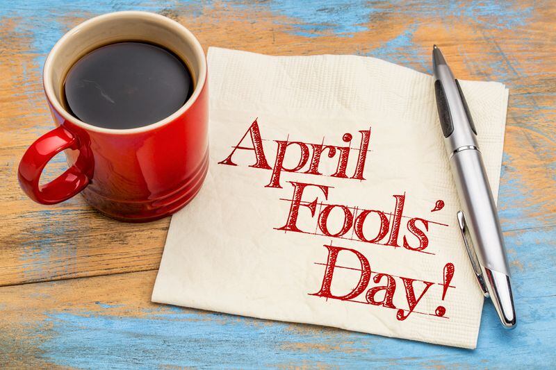 April Fools' Day! Handwriting on a napkin with a cup of coffee