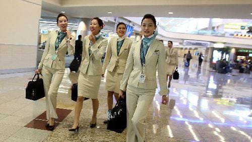 Flight attendants for Korean Air walk on Concourse F in the Internal Terminal at Hartsfield-Jackson International Airport.