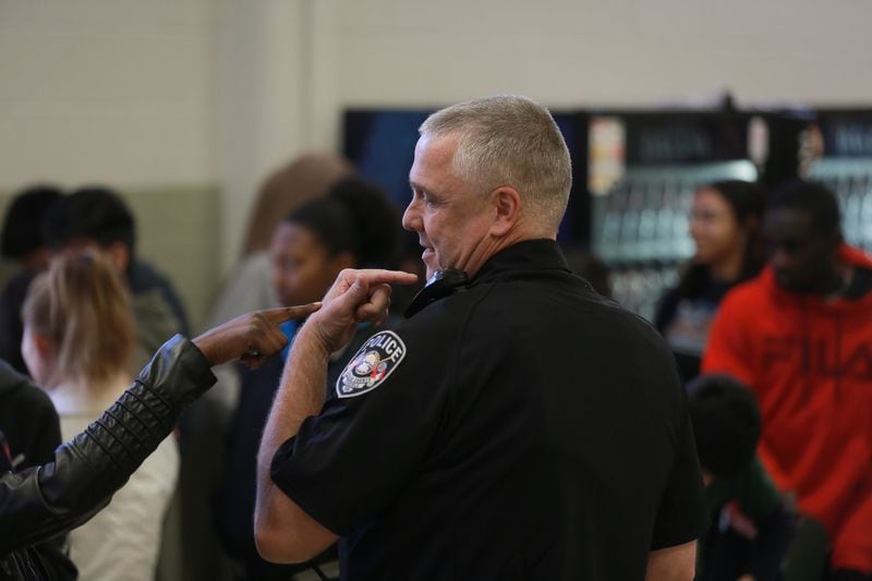 DeKalb County School District school resource officer Johnny Burnette talks with a student about a 360-degree body camera he wears as part of a pilot program at Clarkston High School. ELIJAH NOUVELAGE/SPECIAL