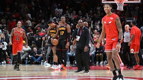 Hawks players react as Chicago Bulls players celebrate their win at the end of  the fourth quarter in an NBA basketball game at State Farm Arena on Wednesday, December 21, 2022. (Hyosub Shin / Hyosub.Shin@ajc.com)
