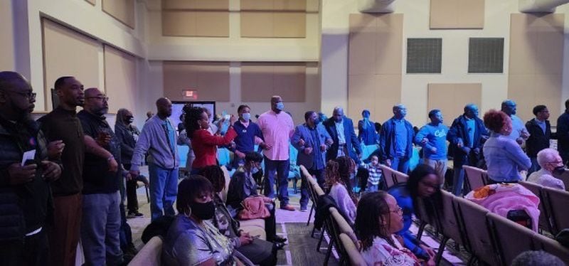The Rev. Wilbur T. Purvis III, pastor of Destiny World Church, asked all the men and boys to stand and lock arms to show solidarity and the connection between them at Sunday's service on Jan. 29, 2023. The repeated a creed and affirmations.