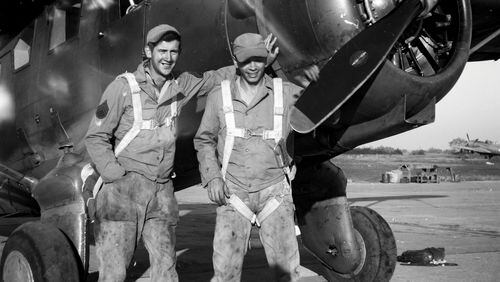 Master Sgt. Jim Galloway (left) in greasy overalls and parachute during World War II.