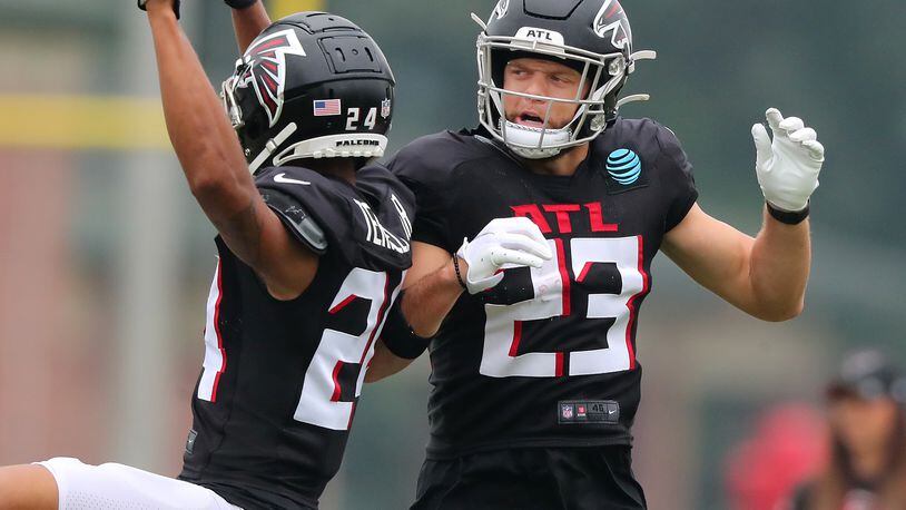 Falcons safety Erik Harris (right) celebrates his interception with cornerback A.J. Terrell (left) during the first day in pads at training camp Tuesday, Aug. 3, 2021, in Flowery Branch. (Curtis Compton / Curtis.Compton@ajc.com)