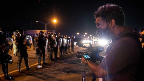 June 13, 2020 Ryon Horne photojournalist for the AJC records protestors and police on I-75 after the Rayshard Brooks shooting. (Ben Grey for The Atlanta Journal-Constitution)