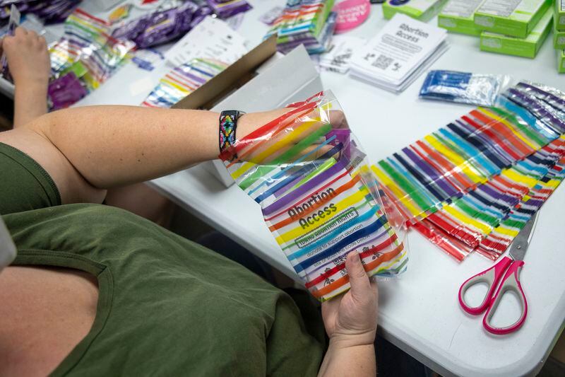 Volunteers assemble reproductive health kits during a reproductive health kit packing party held at The Community Center in Boise, Idaho, on Friday, April 12, 2024. (AP Photo/Kyle Green)