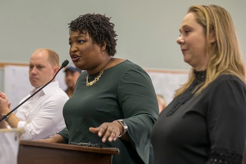 10/29/2018 -- Madison, Georgia -- Gubernatorial candidate Stacey Abrams is joined by Democratic candidate for Lieutenant Governor Sarah Riggs Amico (right) and Democratic Attorney General candidate Charlie Bailey (left) as she speaks during an early voters rally in Madison, Monday, October 29, 2018.  (ALYSSA POINTER/ALYSSA.POINTER@AJC.COM)