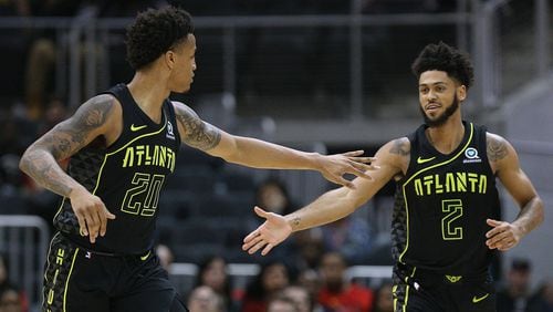 Hawks John Collins gets five from Tyler Dorsey after they scored against the Grizzlies during the fourth period in a 108-82 victory during a NBA basketball game on Tuesday, Feb 6, 2018, in Atlanta.     Curtis Compton/ccompton@ajc.com