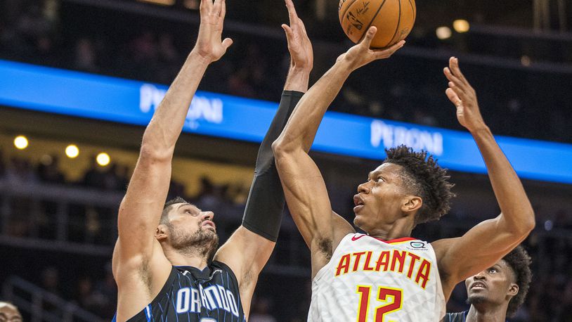 Hawks forward De'Andre Hunter (12) shoots against the Orlando Magic during the first half of an exhibition game at State Farm Arena in Atlanta, Wednesday, October 9, 2019. (Alyssa Pointer/Atlanta Journal Constitution)