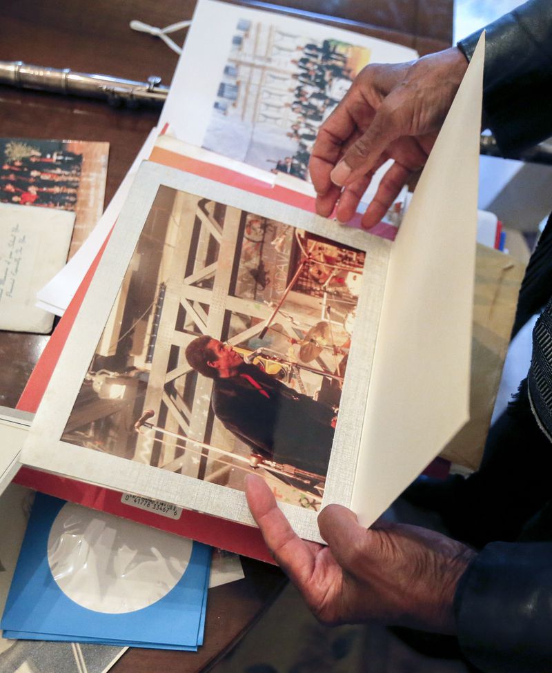James Patterson flips through old photos of his career at his home in Atlanta on Friday, July 2, 2021. Patterson is a longtime jazz musician as well as an associate music professor at Clark Atlanta University. (Christine Tannous / christine.tannous@ajc.com)
