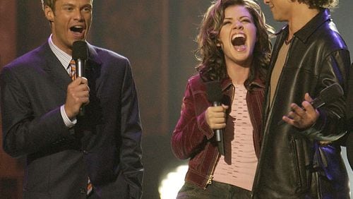 Ryan Seacrest bestowing the first "American Idol" crown in August, 2002 to Kelly Clarkson over Justin Guarini. CREDIT: Fox