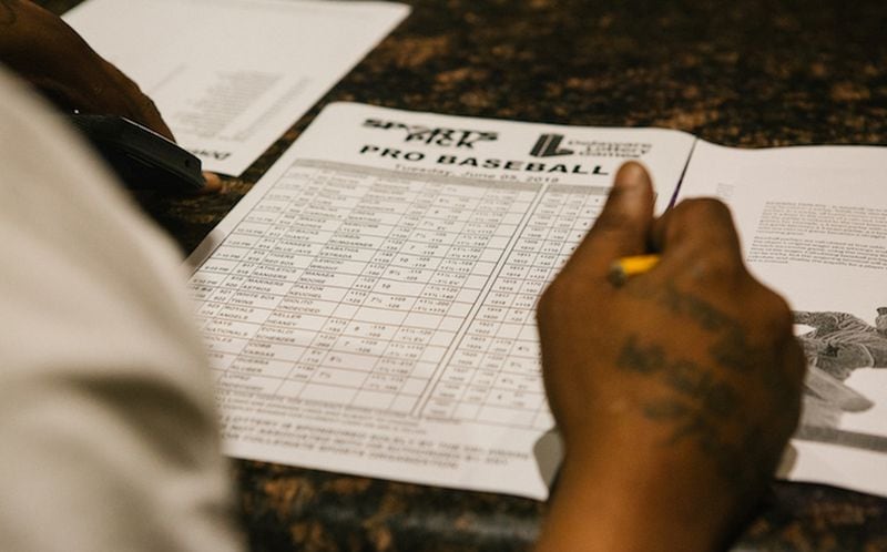 A guest fills out a pick sheet during the launch of full-scale sports betting in Dover, Delaware, on June 5.  Bloomberg photo by Michelle Gustafson