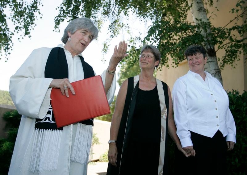FILE - The Reverend Dr. Jane Spahr, left, a Presbyterian minister, performs a same-sex marriage for Sherrie Holmes, center, and Sara Taylor, right, at the Marin Civic Center in San Rafael, Calif., Friday, June 20, 2008. When the United Methodist Church removed anti-LGBTQ language from its official rules in recent days, it marked the end of a half-century of debates over LGBTQ inclusion in mainline Protestant denominations. The moves sparked joy from progressive delegates, but the UMC faces many of the same challenges as Lutheran, Presbyterian and Episcopal denominations that took similar routes, from schisms to friction with international churches to the long-term aging and shrinking of their memberships. (AP Photo/Eric Risberg, File)