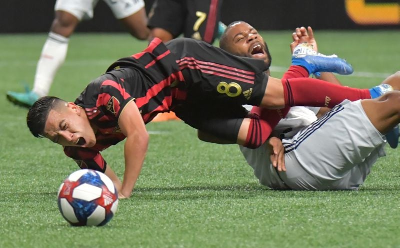 October 19, 2019 Atlanta - Atlanta United midfielder Ezequiel Barco (8) collies with New England Revolution defender Andrew Farrell (2) in the second half during the first round of the MLS playoffs at Mercedes-Benz Stadium on Saturday, October 19, 2019. Atlanta United won 1-0 over the New England Revolution. (Hyosub Shin / Hyosub.Shin@ajc.com)
