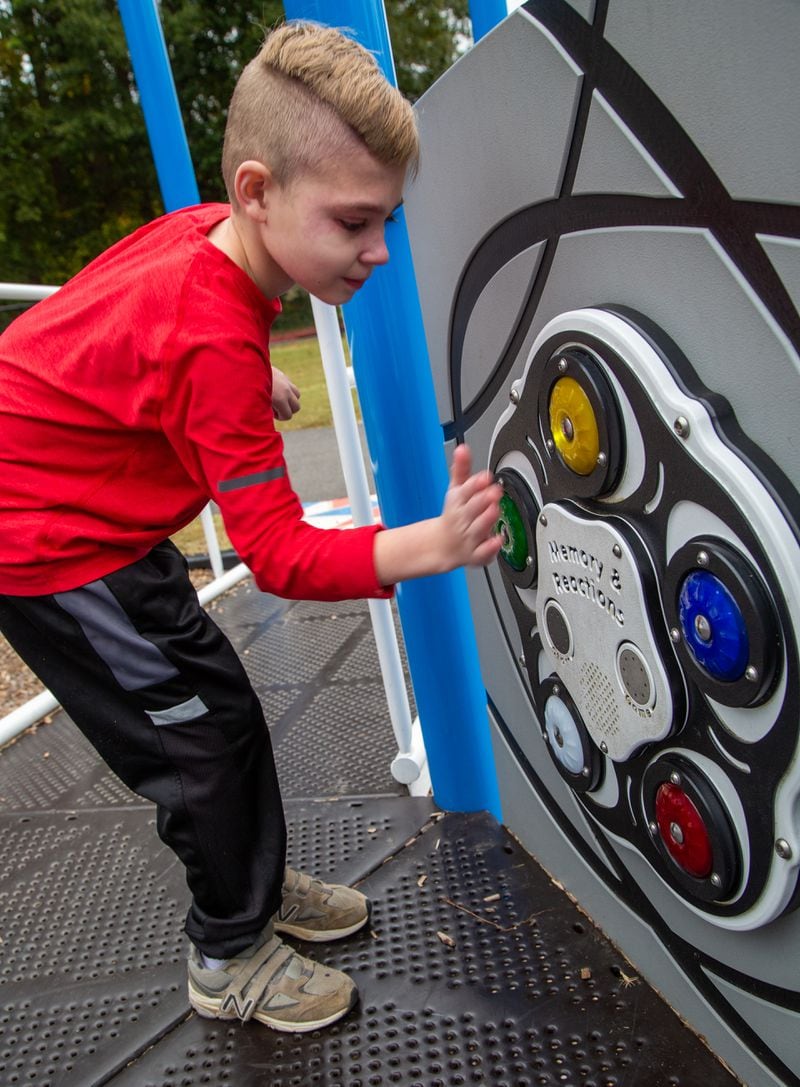Bryce Davis (age 10) plays a memory game at the all-inclusive playground at Alpharetta Elementary School. For Inspire Atlanta story on the Resurgens Charitable Foundations that helps build playgrounds like this one. PHIL SKINNER FOR THE ATLANTA JOURNAL-CONSTITUTION.
