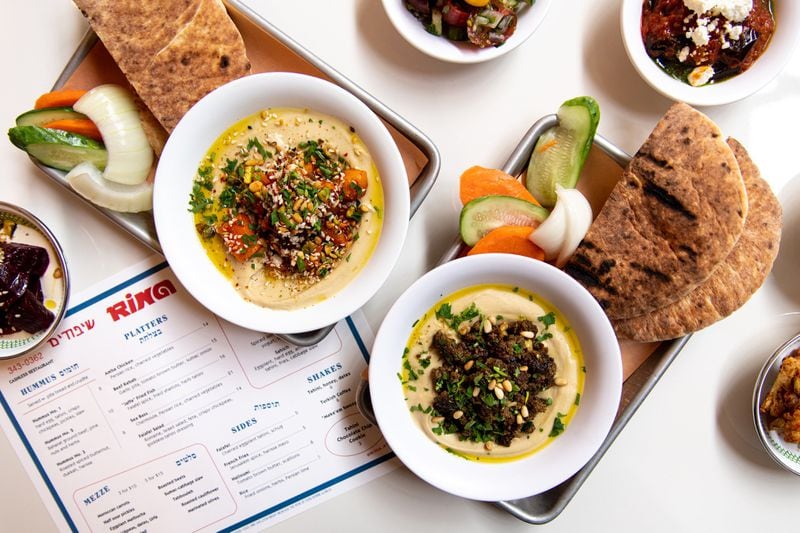 Rina Hummus No. 3 with roasted spiced butternut, dukkah, and harissa, and Hummus No. 2 with Baharat ground beef, pine nuts, and herbs. Photo credit- Mia Yakel.