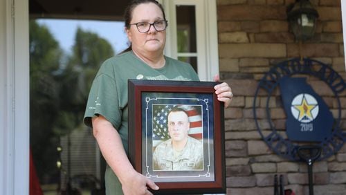 Candice King holds a photograph while reflecting on her son, SCP Ryan C. King. King outside at her house in Canton. King served in Afghanistan during Operation Enduring Freedom and was killed on May 1, 2009. Wednesday, May 18, 2022. Miguel Martinez / miguel.martinezjimenez@ajc.com