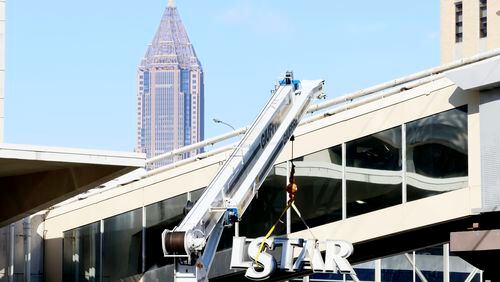 The doors to Wellstar Atlanta Medical Center downtown closed Tuesday at midnight, and crew members have already started to remove the signs over the bridge on Boulevard. Miguel Martinez / miguel.martinezjimenez@ajc.com
