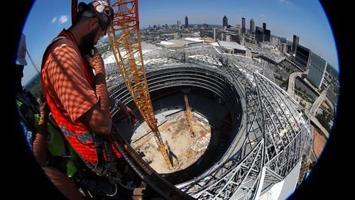 Demand for construction workers seemed to peak in the past several years when they were needed for building two huge stadiums and a number of high-rises. Here, a worker takes in the view from the the top of Falcons Mercedes-Benz Stadium during the final stages of construction. Curtis Compton/ccompton@ajc.com