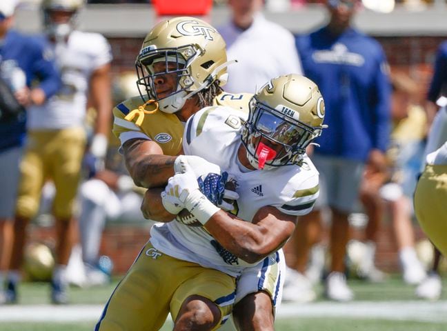 Georgia Tech linebacker E.J. Lightsey (2) bottles up Georgia Tech running back Anthony Carrie (6) during the Spring White and Gold game at Bobby Dodd Stadium at Hyundai Field In Atlanta on Saturday, April 13, 2024.   (Bob Andres for the Atlanta Journal Constitution)