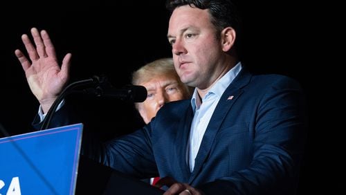 Georgia lieutenant gubernatorial candidate and Republican state Sen. Burt Jones speaks at a September rally in Perry as former U.S. President Donald Trump watches. Some Republicans are expressing concern that down-ticket Republican candidates could be hurt by Jones' involvement in a plan to use a fake slate of electors to overturn Trump's defeat in Georgia's 2020 presidential election. (Sean Rayford/Getty Images/TNS)