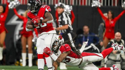 Atlanta Falcons running back Tevin Coleman (26) is tackled by Arizona Cardinals defensive back Tre Boston (33) near the10-yard-line after running the ball during the first half of the game at Mercedes-Benz Stadium in Atlanta, Sunday, December 16, 2018.  (ALYSSA POINTER/ALYSSA.POINTER@AJC.COM)
