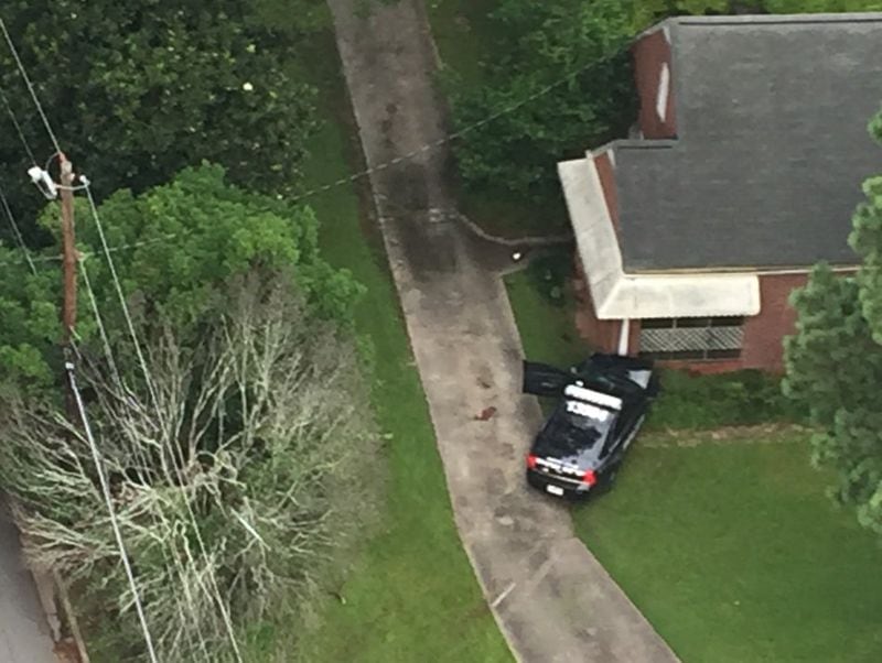 A DeKalb County police cruiser crashed into a house early Tuesday after hitting a jogger, authorities said. (Credit: Channel 2 Action News)