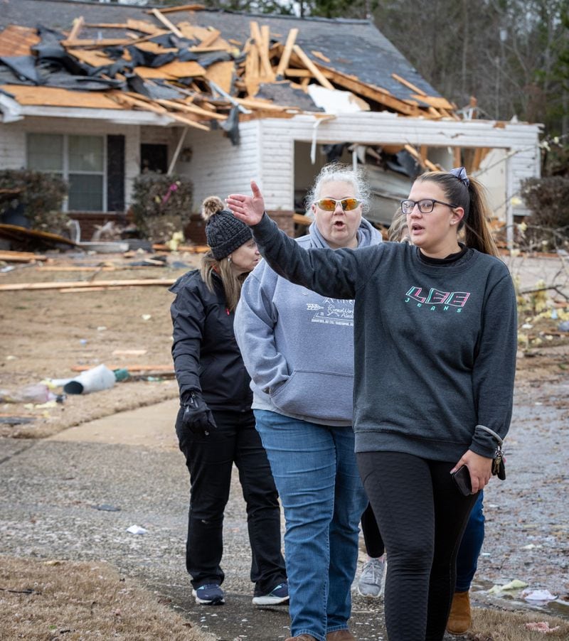 Clearview Elementary School teachers who volunteered to help people with tornado-damaged homes walk around the Lexington Park neighborhood in LaGrange Friday, Jan 13, 2023.   (Steve Schaefer/steve.schaefer@ajc.com)