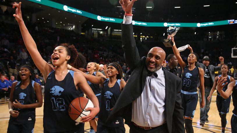 March 9, 2018 - Atlanta, Ga: Lovejoy coach Cedric King, right, guard J'Auana Robinson (12) and other players celebrates their win against Harrison during the GHSA Class AAAAAA Girls State Championship at McCamish Pavilion Friday, March 9, 2018, in Atlanta. Lovejoy won 57-41. PHOTO / JASON GETZ